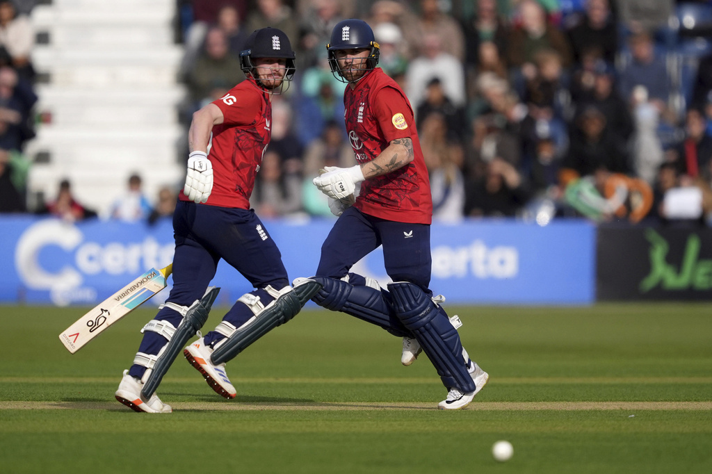 England's Jordan Cox, left, and Phil Salt run between the wickets during the third men's International Twenty20 cricket match at Malahide Cricket Club in Dublin, Ireland, Sunday Sept. 21, 2025. (Brian Lawless/PA via AP)