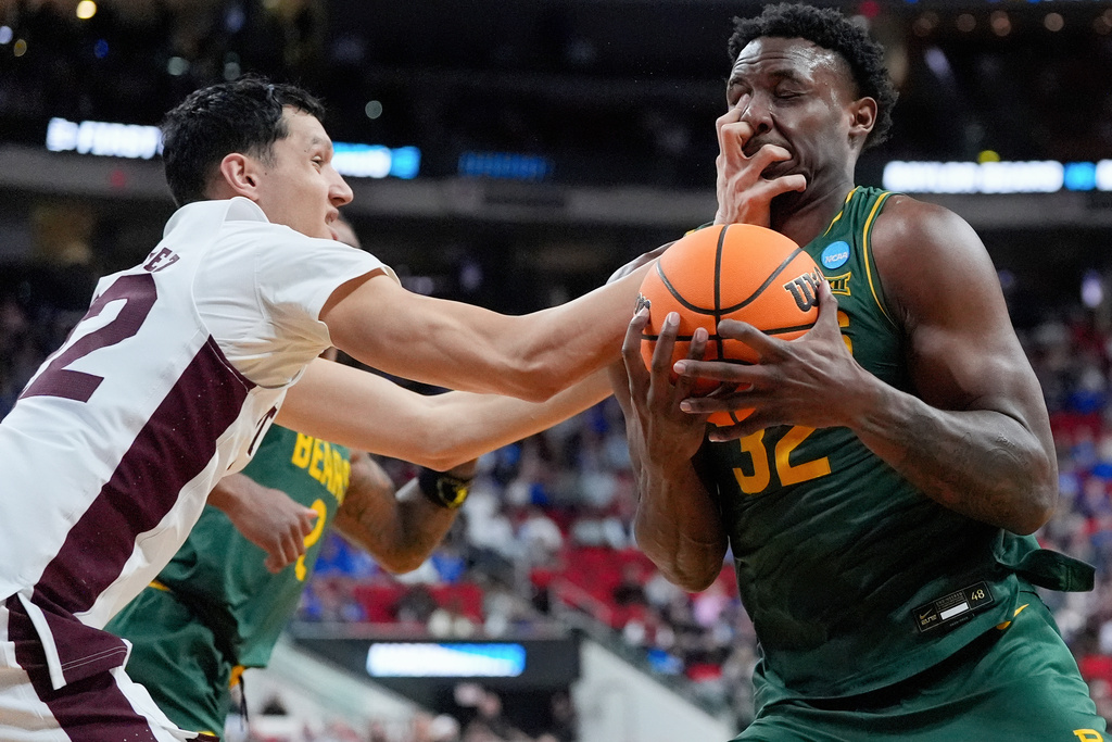 Baylor guard Jalen Celestine (32) is fouled by Mississippi State forward RJ Melendez, left, during the first half in the first round of the NCAA college basketball tournament, March 21, 2025, in Raleigh, N.C. (AP Photo/Stephanie Scarbrough, File)