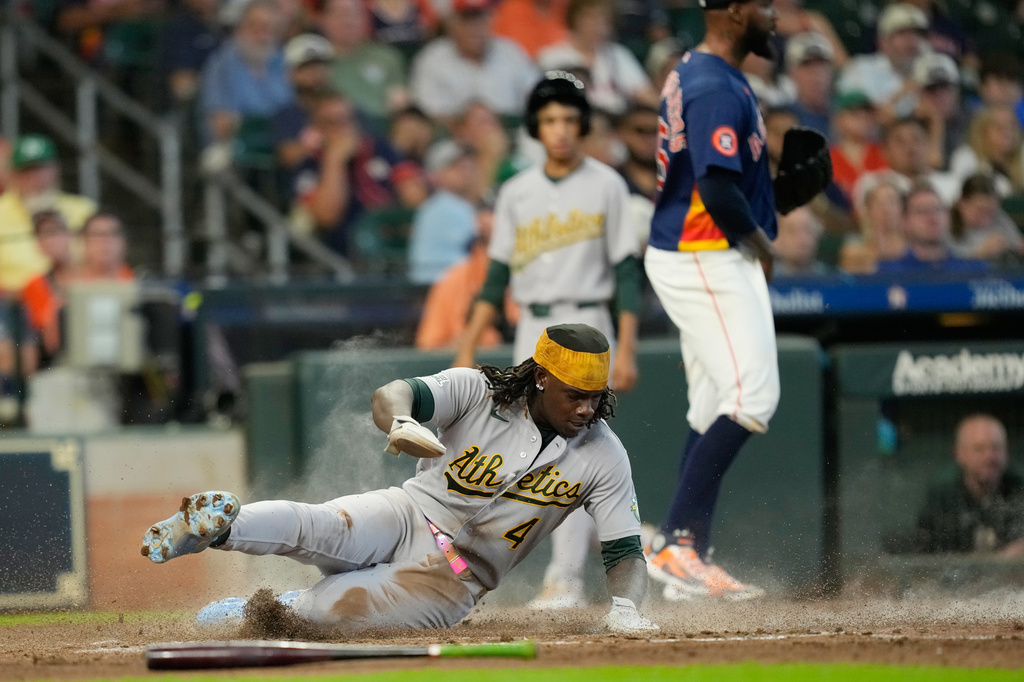 Athletics' Lawrence Butler (4) scores against the Houston Astros during the fifth inning of a baseball game Sunday, Aug. 23, 2026, in Houston. (AP Photo/David J. Phillip)
