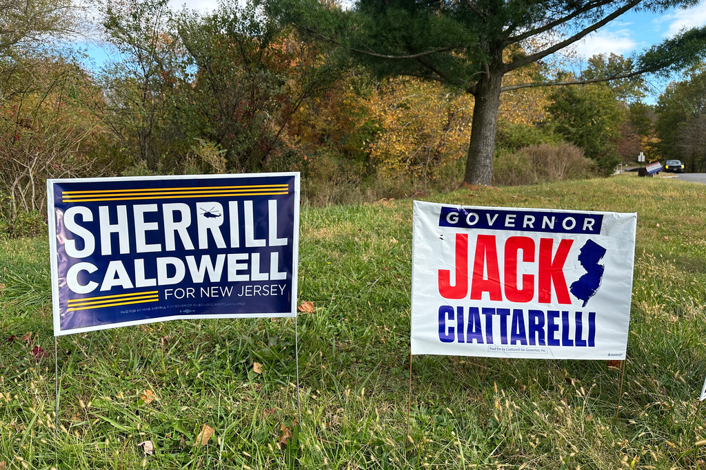 Signs for gubernatorial nominees Democrat Mikie Sherrill and Republican Jack Ciattarelli stand by a roadside in Warren, N.J., Thursday, Oct. 23, 2025. (AP Photo/Robert Yoon)