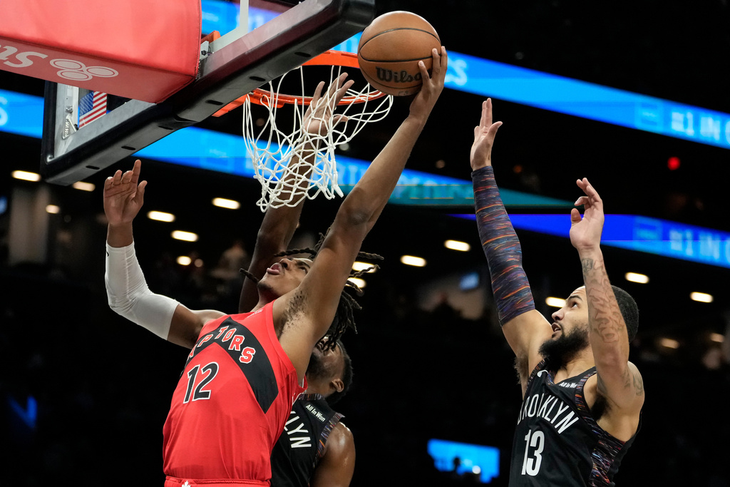 Toronto Raptors forward Collin Murray-Boyles (12) shoots during the first half of an NBA basketball game against the Brooklyn Nets, Sunday, Dec. 21, 2025, in New York. (AP Photo/Yuki Iwamura)