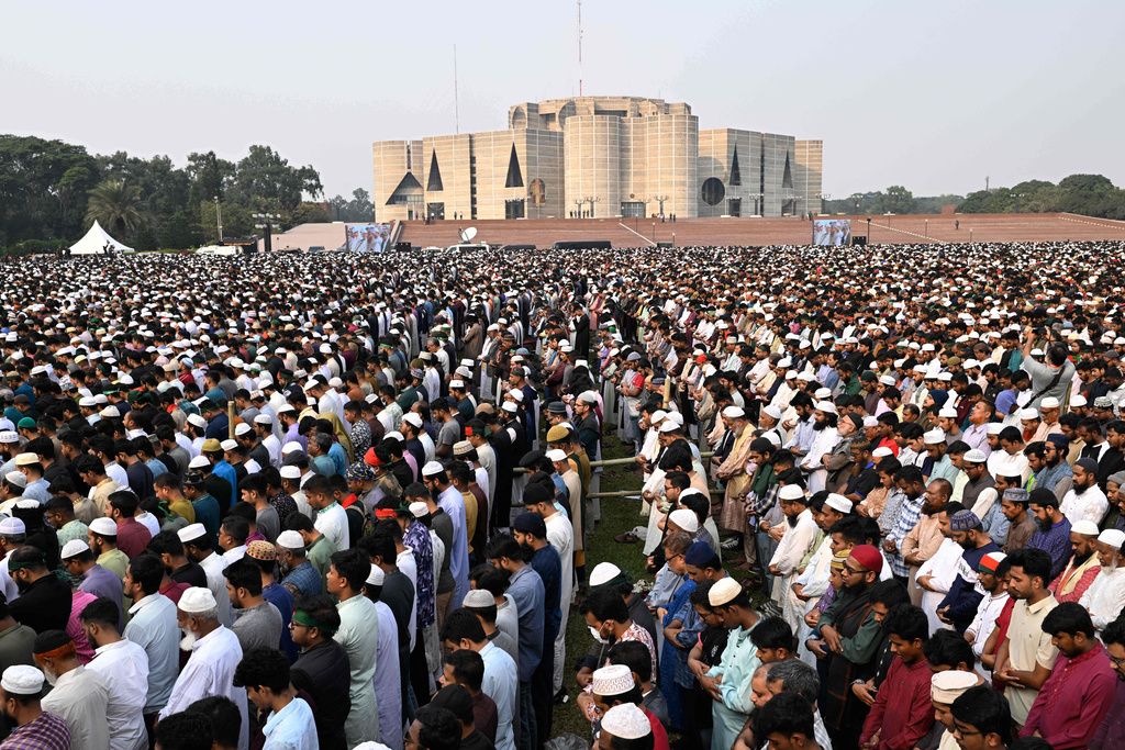 People offer funeral prayers for leading Bangladeshi activist Sharif Osman Hadi, who died from gunshot wounds sustained in an attack in Dhaka earlier this month, outside the nation's Parliament complex in Dhaka, Bangladesh, Saturday, Dec. 20, 2025. (AP Photo/Mahmud Hossain Opu)