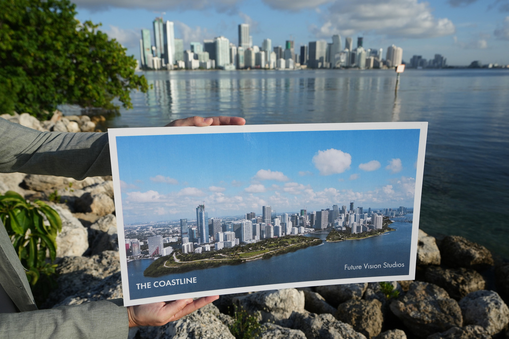 Aaron DeMayo, founder of Future Vision Studios, holds a plan for The Coastline, a regional resilience masterplan proposal to protect Southern Florida from storm surge and sea level rise Wednesday, Aug. 12, 2026, in Miami. (AP Photo/Lynne Sladky)