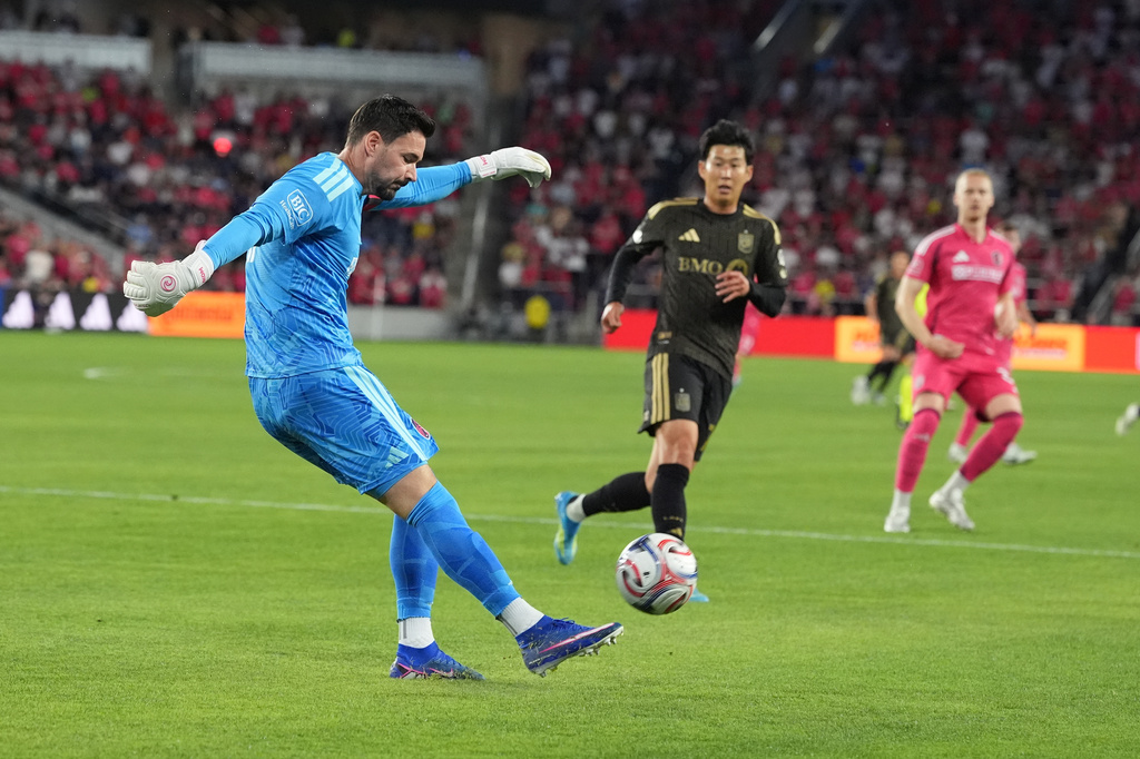 St. Louis City goalkeeper Roman Bürki, left, clears the ball as Los Angeles FC's Son Heung-Min watches during the first half of an MLS soccer match Wednesday, May 13, 2026, in St. Louis. (AP Photo/Jeff Roberson)