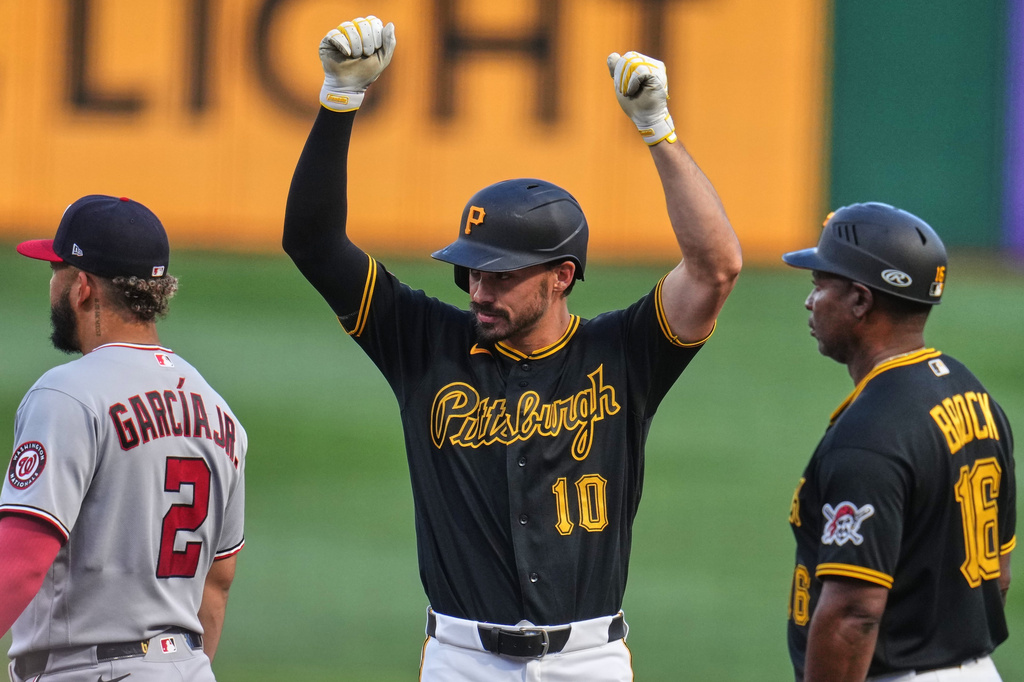 Pittsburgh Pirates' Bryan Reynolds (10) celebrates as he stands on first base after driving in a run with a single off Washington Nationals pitcher Cade Cavalli (not shown) during the second inning of a baseball game in Pittsburgh, Monday, April 13, 2026. (AP Photo/Gene J. Puskar)