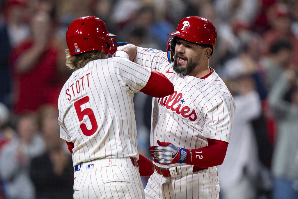 Philadelphia Phillies' Kyle Schwarber, right, reacts to his three-run home run with Bryson Stott, left, during the seventh inning of a baseball game against the New York Mets, Tuesday, Sep. 9, 2025, in Philadelphia. (AP Photo/Chris Szagola)