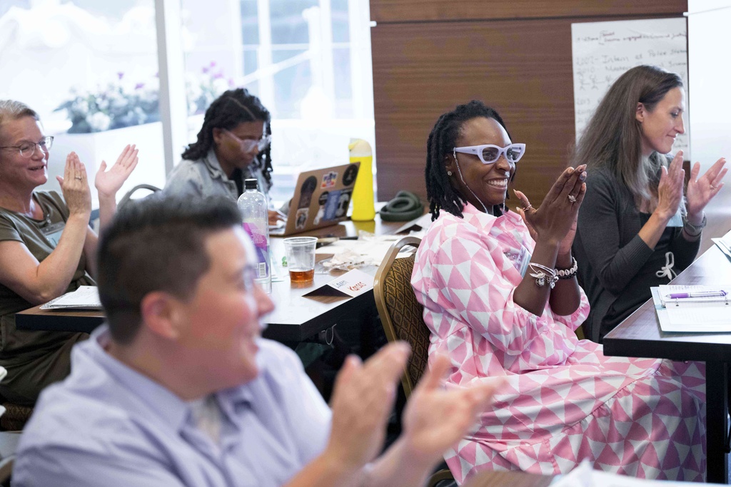 Cedrita Demus, second right, who is considering running for Tallahassee, Fla. city commissioner district, applauds during the Emerge America Southern Regional Boot Camp, a camp designed for Democratic women to improve their political campaigns, in New Orleans, Aug. 10, 2025. (AP Photo/Matthew Hinton)
