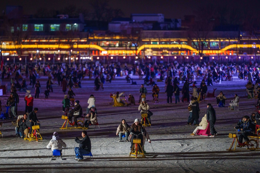 Visitors skate across a frozen lake at Shichahai in Beijing, China, Sunday, Jan. 18, 2026. (AP Photo/Vincent Thian)