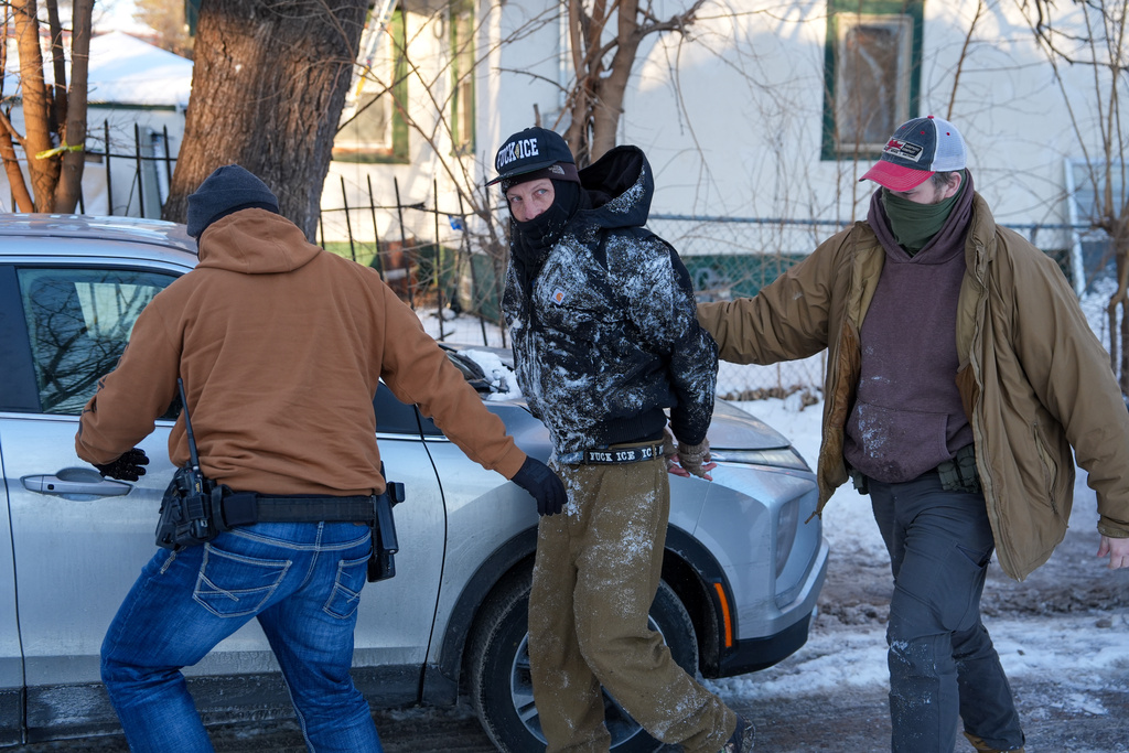 FILE - An activist is detained by federal agents on Tuesday, Feb. 3, 2026, in Minneapolis. (AP Photo/Ryan Murphy, File)