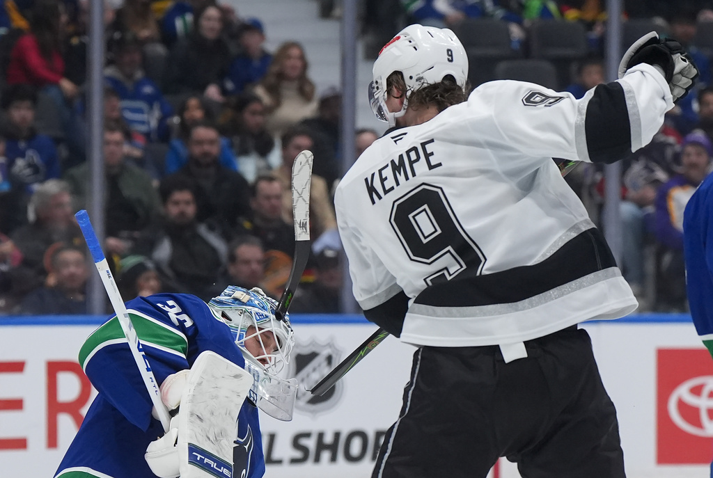The stick of Los Angeles Kings' Adrian Kempe (9) breaks in front of Vancouver Canucks goalie Kevin Lankinen (32) after being hit by the puck during the second period of an NHL hockey game, in Vancouver, on Tuesday, April 14, 2026. (Darryl Dyck/The Canadian Press via AP)