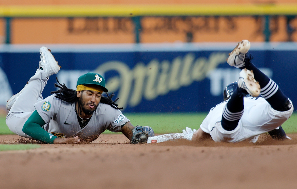 Athletics second baseman Joshua Kuroda-Grauer (44) makes a diving tag to get the force out on Detroit Tigers' Zach McKinstry during the sixth inning of a baseball game Wednesday, July 8, 2026, in Detroit. (AP Photo/Duane Burleson)