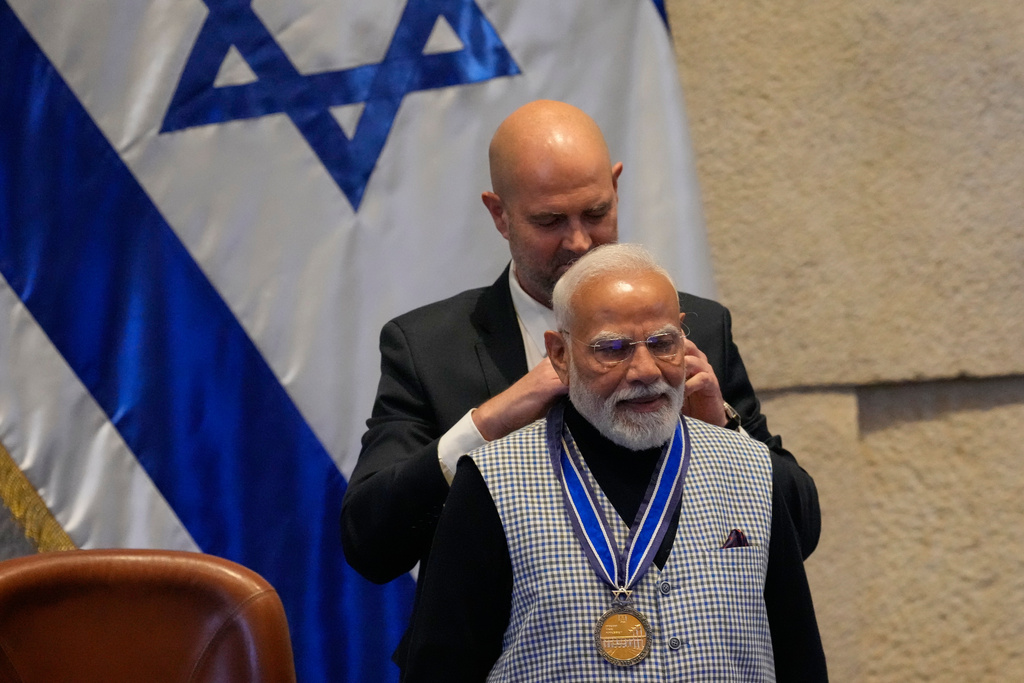 Israel's Parliament Speaker Amir Ohana presents a medal to Indian Prime Minister Narendra Modi , after addressing lawmakers in the Knesset, Israel's parliament, in Jerusalem, Wednesday, Feb. 25, 2026. (AP Photo/Ohad Zwigenberg)