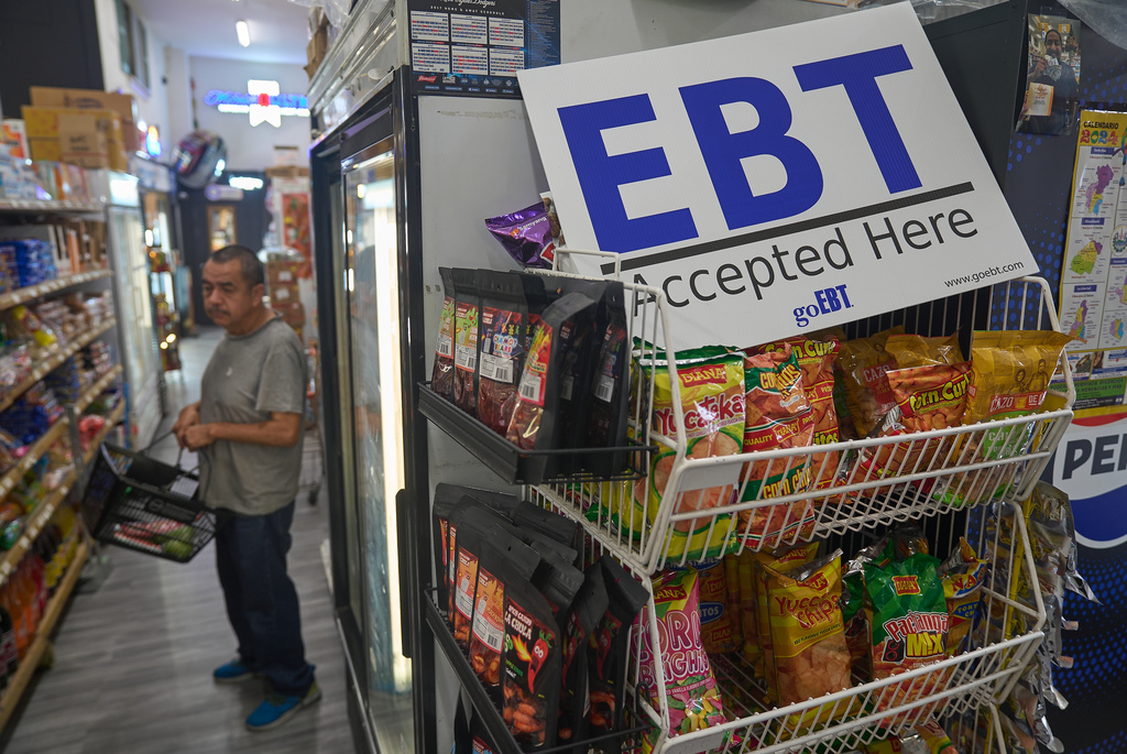 FILE - A banner reads: "EBT (Electronic Benefit Transfer) Accepted Here," at El Recuerdo Market in Los Angeles, Oct. 31, 2025, after two federal judges ordered President Donald Trump's administration to continue funding SNAP during the government shutdown. (AP Photo/Damian Dovarganes, file)