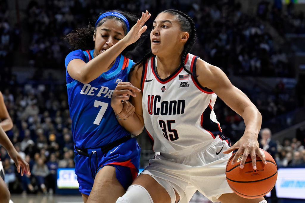 UConn guard Azzi Fudd (35) drives to the basket as DePaul guard Devin Hagemann (7) defends in the first half of an NCAA college basketball game, Sunday, Dec. 7, 2025, in Storrs, Conn. (AP Photo/Jessica Hill)