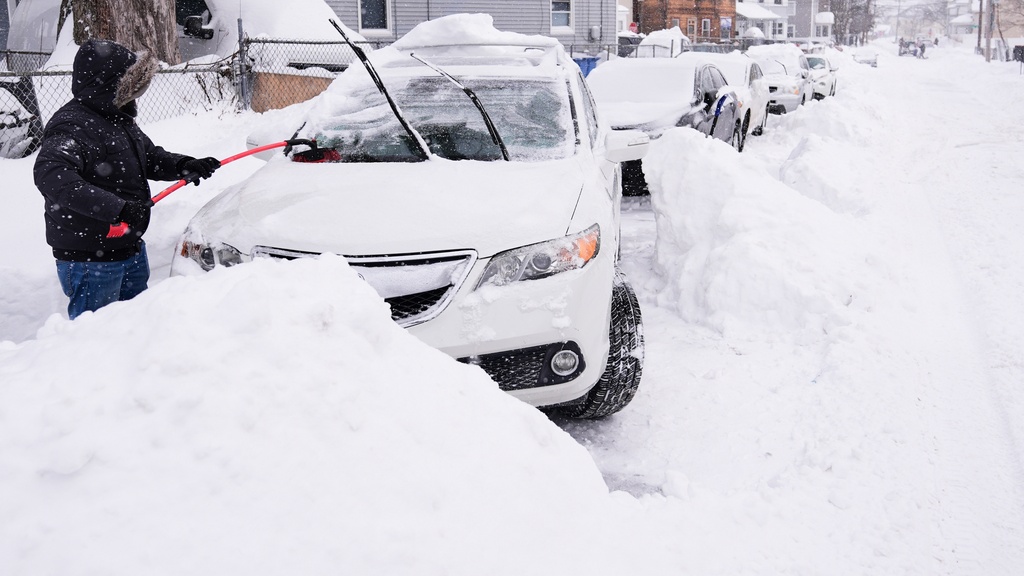 FILE - Rafael Tavares digs his car, which was encased about 20 inches of snow, during a winter storm Jan. 26, 2026, in Lawrence, Mass. (AP Photo/Charles Krupa, File)