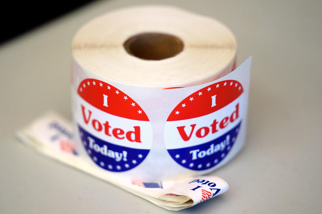 FILE - A spool of stickers rests on a table at a polling station during Massachusetts state primary voting, Sept. 3, 2024, at the Newton Free Library, in Newton, Mass. (AP Photo/Steven Senne, File)