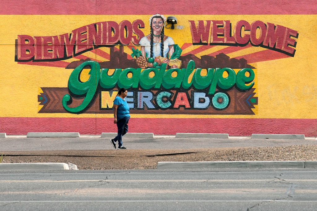 A person walks past a mural promoting Guadalupe, Ariz., May 19, 2026. (AP Photo/Ross D. Franklin)