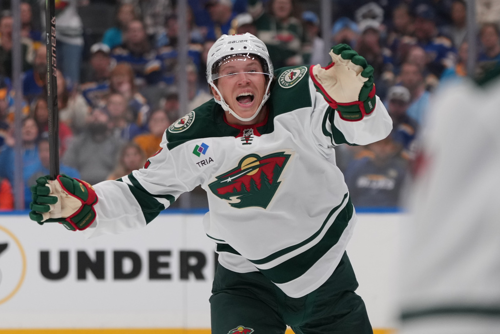 Minnesota Wild's Matt Boldy (12) celebrates after scoring during the first period of an NHL hockey game against the St. Louis Blues Thursday, Oct. 9, 2025, in St. Louis. (AP Photo/Jeff Roberson)