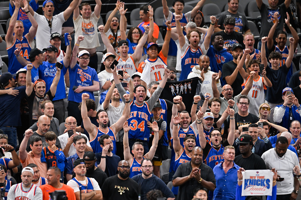 New York Knicks fans celebrate after defeating the San Antonio Spurs in Game 5 of the NBA Finals basketball series, Saturday, June 13, 2026, in San Antonio. (AP Photo/Darren Abate)