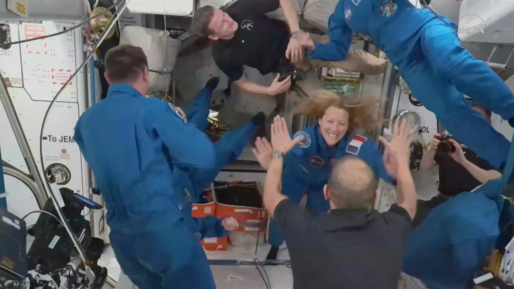In this image from video provided by NASA, France’s Sophie Adenot, Russia’s Andrei Fedyaev and Americans Jessica Meir and Jack Hathaway greet colleagues as they enter the International Space Station after arriving on a SpaceX Dragon capsule on Saturday, Feb. 14, 2026. (NASA via AP)