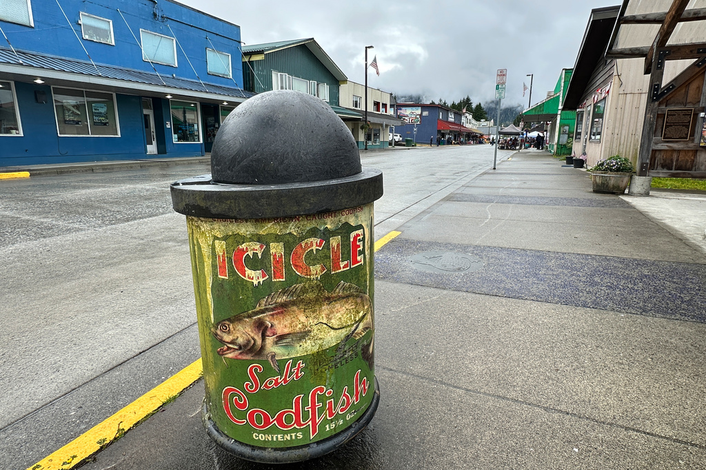 This trash can, shown on Saturday, July 4, 2026, is one of numerous bins in Petersburg, Alaska, whose design is inspired by fish and seafood canning labels historically linked to canneries in the community. (AP Photo/Becky Bohrer)
