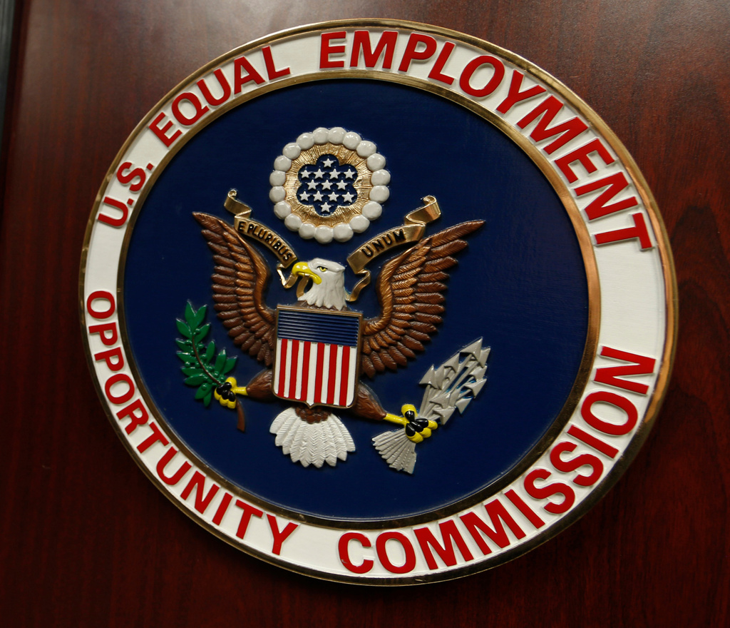 FILE - The emblem of the U.S. Equal Employment Opportunity Commission (EEOC) is displayed on a podium in Vail, Colo., Feb. 16, 2016. (AP Photo/David Zalubowski, File)