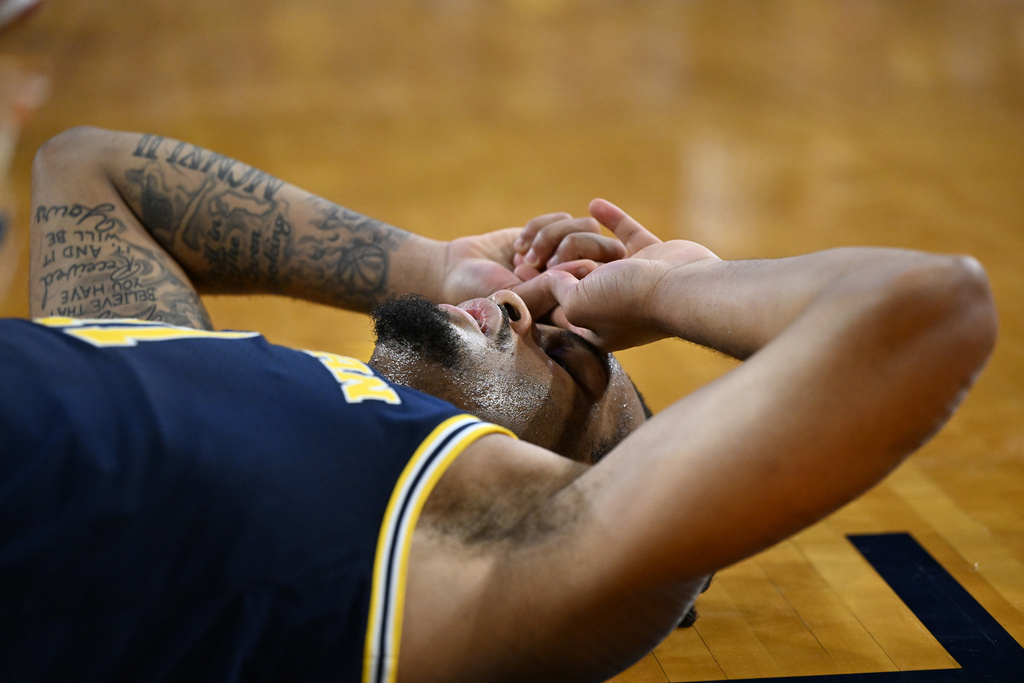 Michigan guard Roddy Gayle Jr. (11) lies on the court after missing a layup against the Wisconsin in the second half of an NCAA college basketball game in Ann Arbor, Mich., Saturday, January 10, 2026. (AP Photo/Lon Horwedel)