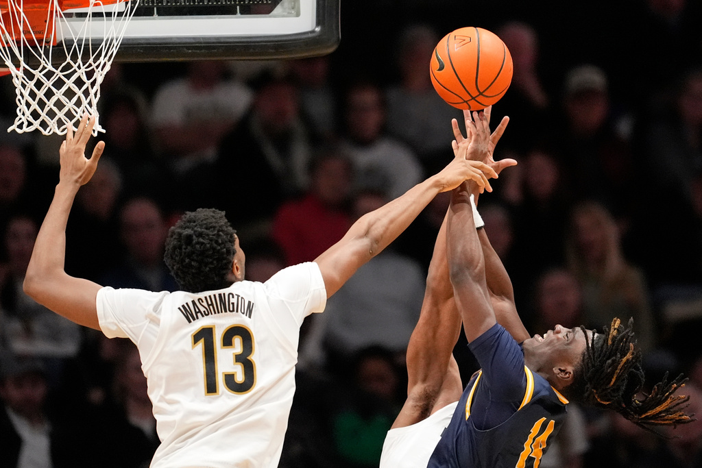 New Haven guard Teshaun Steele (14) is fouled as he shoots the ball by Vanderbilt forward Jalen Washington (13) during the first half of an NCAA college basketball game Monday, Dec. 29, 2025, in Nashville, Tenn. (AP Photo/George Walker IV)