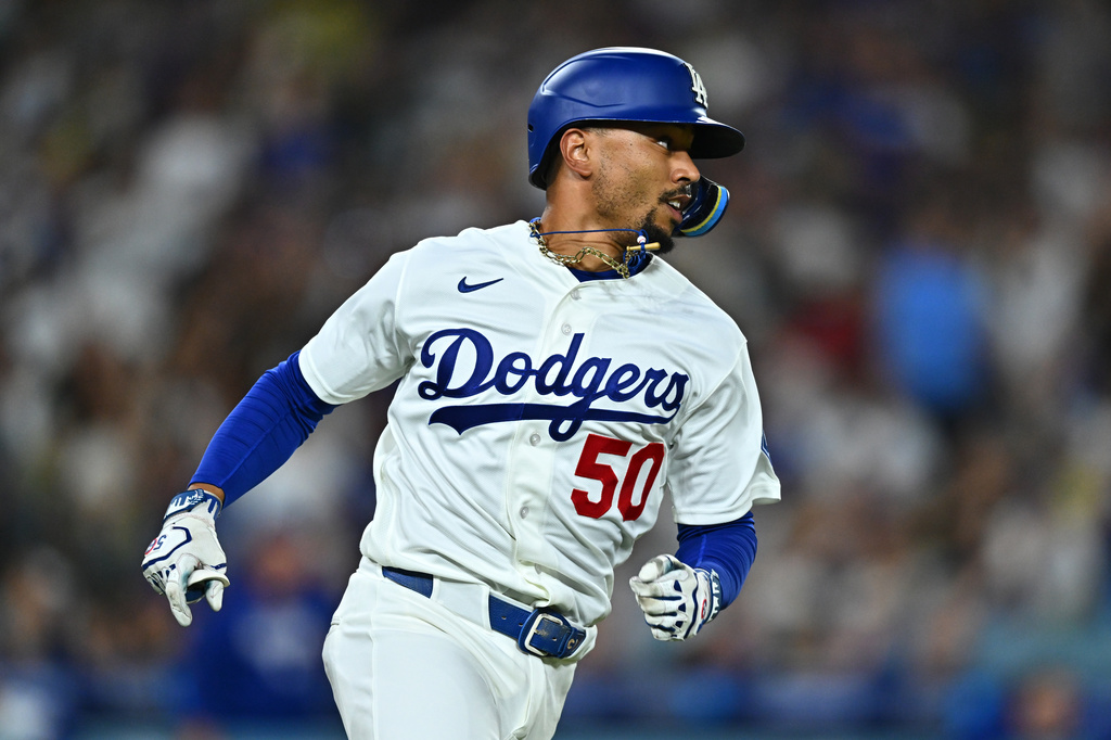 Los Angeles Dodgers' Mookie Betts runs after hitting an RBI single during the third inning of a baseball game against the Washington Nationals, Friday, Sept. 4, 2026, in Los Angeles. (AP Photo/William Liang)