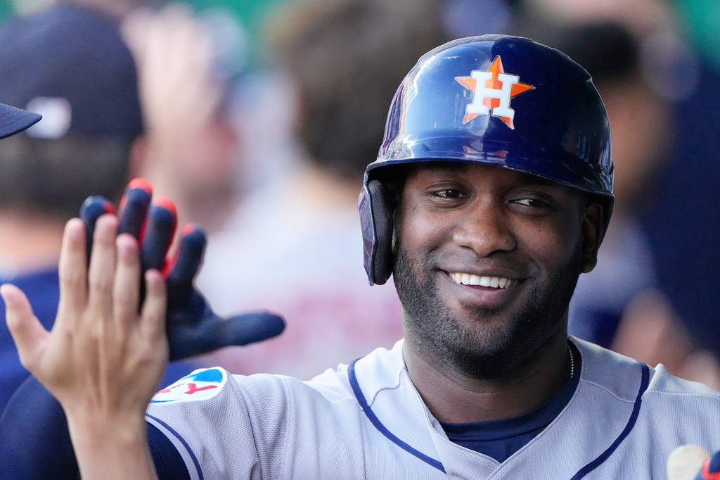 Houston Astros' Yordan Alvarez celebrates in the dugout after hitting a grand slam during the first inning of a baseball game against the Kansas City Royals, Friday, June 12, 2026, in Kansas City, Mo. (AP Photo/Charlie Riedel)
