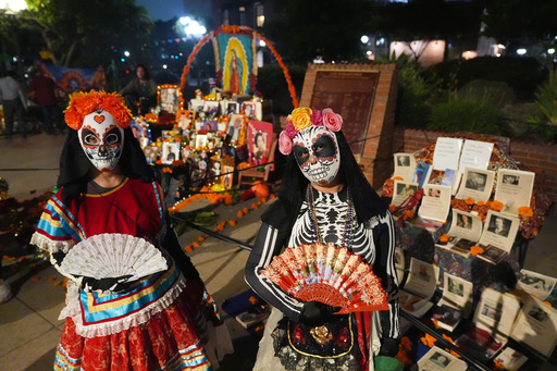 People join Olvera Street merchants in a night procession during the Day of the Death festival, Sunday, Oct. 26, 2025, in Los Angeles. (AP Photo/Damian Dovarganes) People join Olvera Street merchants in a night procession during the Day of the Death festival, Sunday, Oct. 26, 2025, in Los Angeles. (AP Photo/Damian Dovarganes)