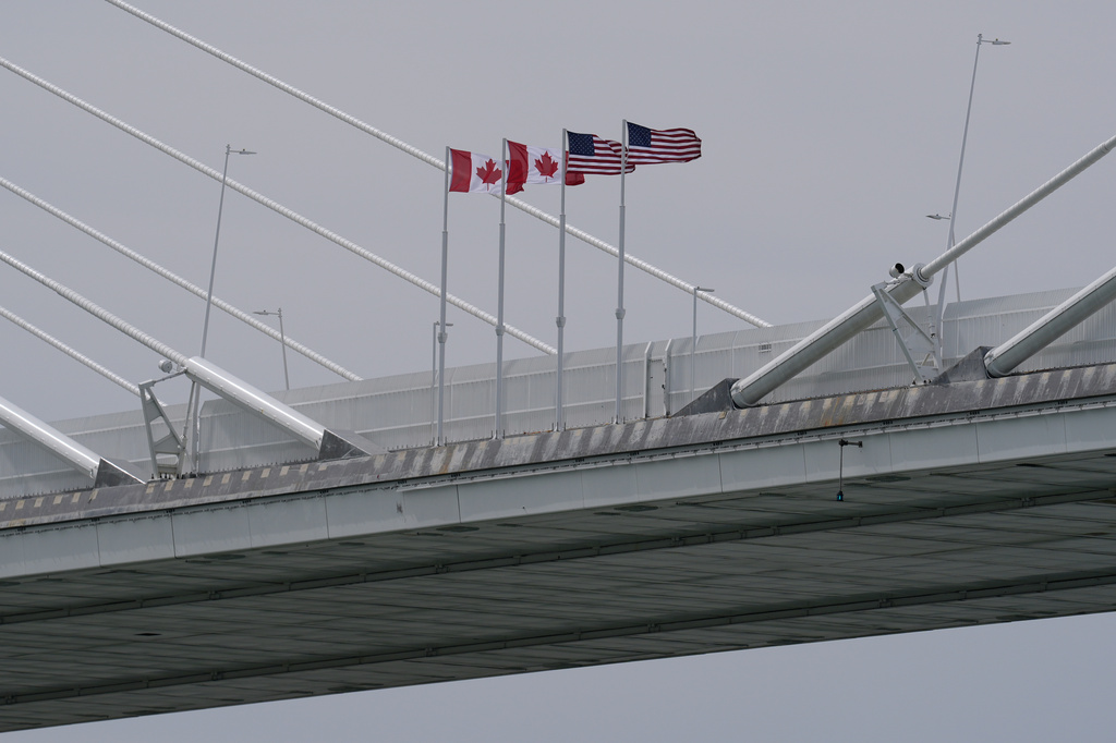 FILE - Canadian and American flags are shown on the Gordie Howe Bridge under construction between Windsor, Ontario and Detroit, May 22, 2026. (AP Photo/Paul Sancya, File)