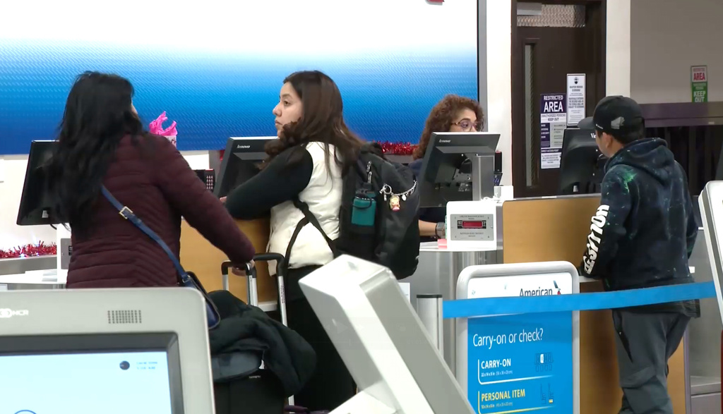 Passengers wait in line at the El Paso International Airport after all flights were grounded on Wednesday, Feb. 11, 2026. (KFOX via AP)