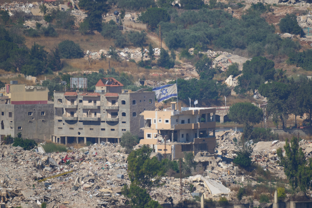 An Israeli flag tops a destroyed building in southern Lebanon, as seen from northern Israel, Sunday, June 28, 2026. (AP Photo/Ohad Zwigenberg)