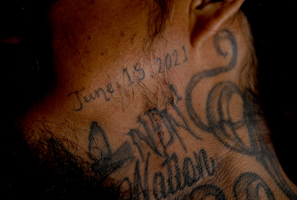 Gerald Begay, whose mother Ella Mae Begay went missing from her home, shows a neck tattoo memorializing her in his home in Denver, April 2, 2026. (AP Photo/Thomas Peipert)