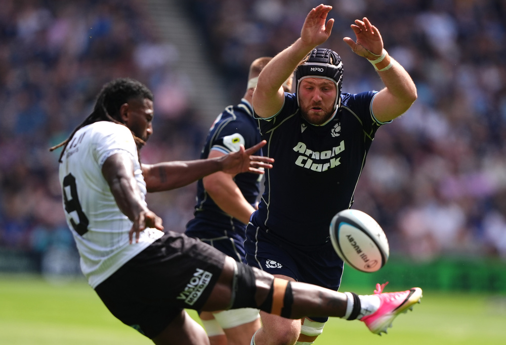 Fiji's Frank Lomani performs a box kick that is charged down by Scotland's George Horne during the Nations Championship match between Scotland and Fiji, at Scottish Gas Murrayfield Stadium in Edinburgh, Scotland, Saturday July 18, 2026. (Andrew Milligan/PA via AP)