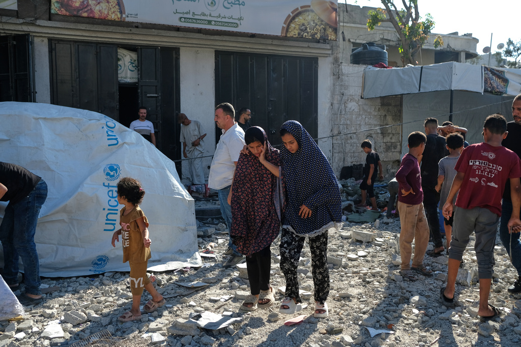 Residents inspect the site of an Israeli airstrike in Gaza city, Saturday, July 18, 2026. (AP Photo/Jehad Alshrafi)