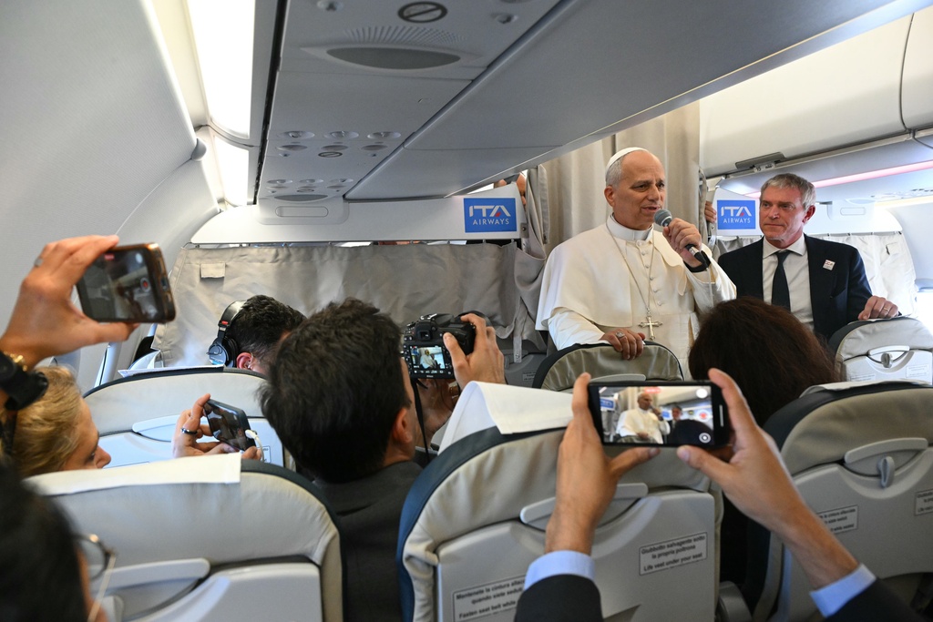 Pope Leo XIV talks to reporters aboard an aircraft on his way to Beirut, Lebanon, Sunday, Nov. 30, 2025. (Andreas Solaro/Pool Via AP)