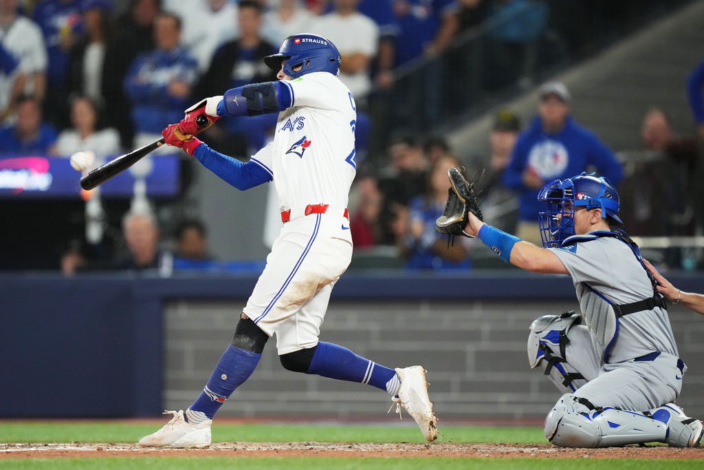 Toronto Blue Jays' Ernie Clement hits a double against the Los Angeles Dodgers during the eighth inning in Game 7 of baseball's World Series in Toronto on Saturday, Nov. 1, 2025. (Nathan Denette/The Canadian Press via AP)