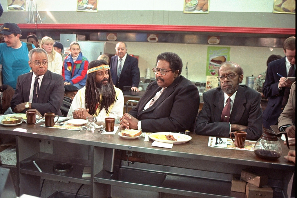 FILE - The four black men who were once denied service at the Woolworth store in Greensboro, N.C. take their places at the same lunch counter to recreate their sit-in on Feb. 2, 1990. The men are, from left, Joseph McNeil, Jibreal Khazan (formerly Ezell Blair, Jr.), Franklin McCain, and David Richmond. (AP Photo/Chuck Burton, File)