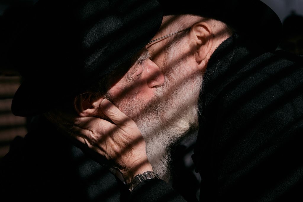 Chabad-Lubavitch rabbis kiss as they gather at the resting place of the Rebbe, Rabbi Menachem M. Schneerson, one of Judaism’s most influential figures, in the Queens borough of New York on Friday, Nov. 14, 2025, during the International Conference of Chabad-Lubavitch Emissaries. (AP Photo/Andres Kudacki)