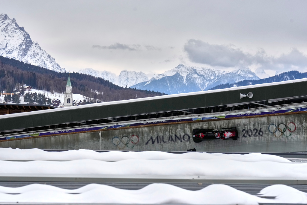 Canada's Taylor Austin, front, and Shaquille Murray-Lawrence slide down the track during a two man bobsled run at the 2026 Winter Olympics, in Cortina d'Ampezzo, Italy, Monday, Feb. 16, 2026. (AP Photo/Aijaz Rahi)