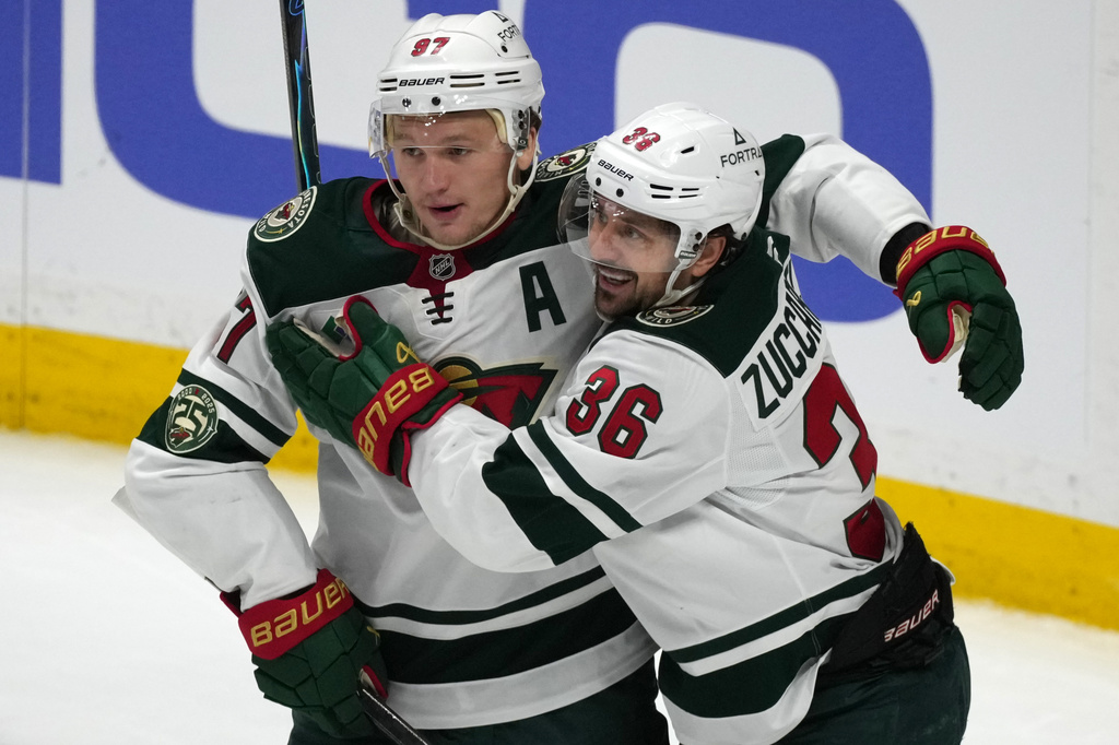 Minnesota Wild left wing Kirill Kaprizov, left, congratulates right wing Mats Zuccarello after he scored a goal against the Colorado Avalanche in the third period of Game 1 of an NHL hockey Stanley Cup second-round playoff series Sunday, May 3, 2026, in Denver. (AP Photo/David Zalubowski)