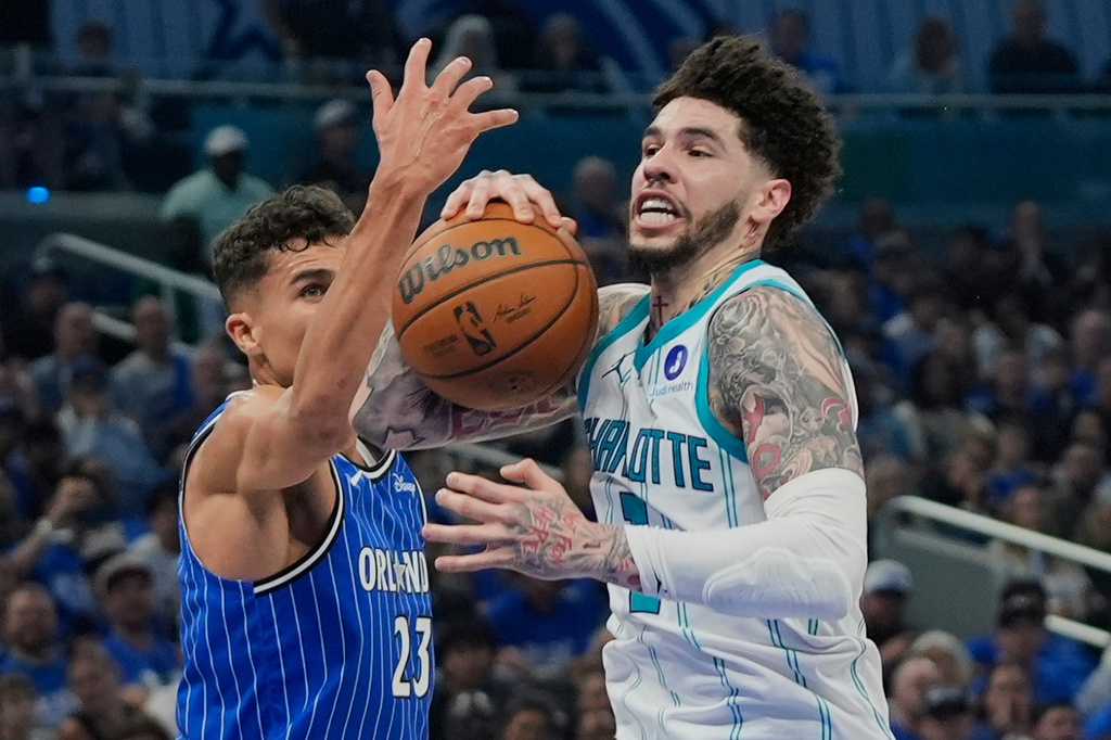 Charlotte Hornets guard LaMelo Ball, right, goes to the basket against Orlando Magic forward Tristan da Silva (23) during the second half of an NBA play-in tournament basketball game, Friday, April 17, 2026, in Orlando, Fla. (AP Photo/John Raoux)