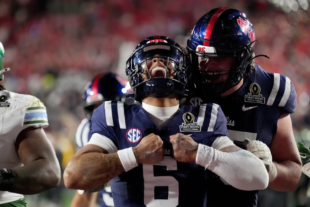 Mississippi quarterback Trinidad Chambliss (6) celebrates scoring on a eight-yard run against Tulane during the second half in the first round of an NCAA College Football Playoff, Saturday, Dec. 20, 2025, in Oxford, Miss. (AP Photo/Rogelio V. Solis)