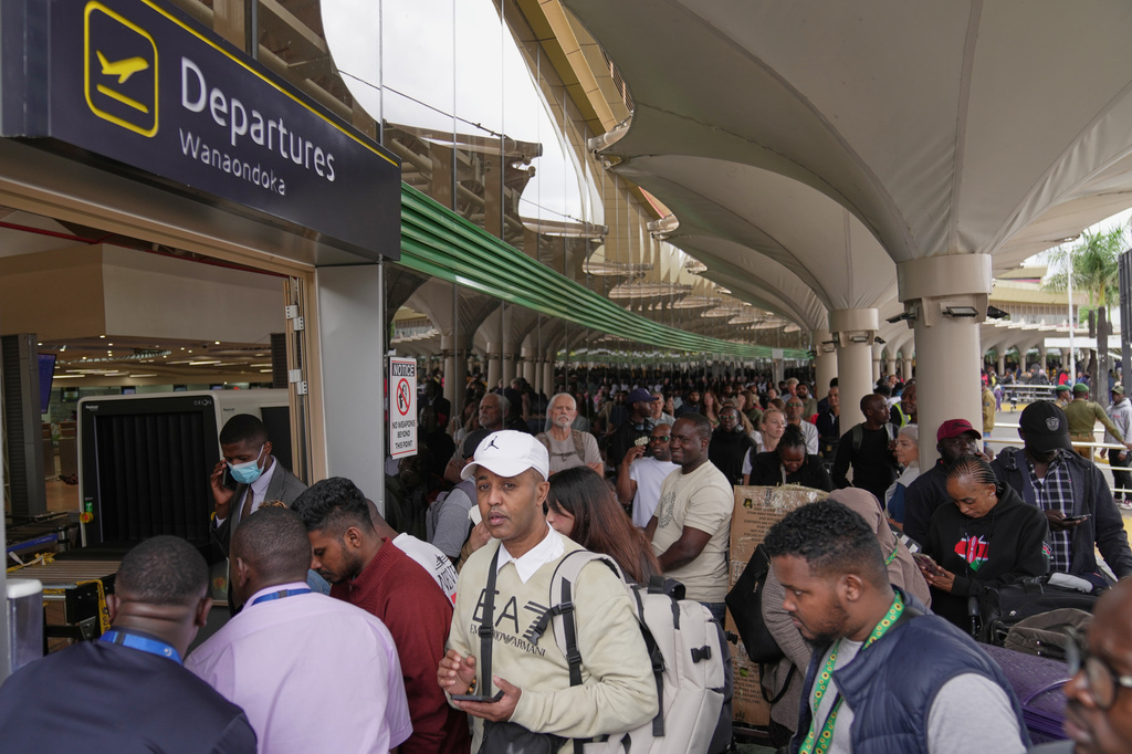 Passengers queue at the departure area during a workers strike at Jomo Kenyatta International Airport in Nairobi, Kenya, Monday, Aug. 31, 2026. (AP Photo/Brian Inganga)
