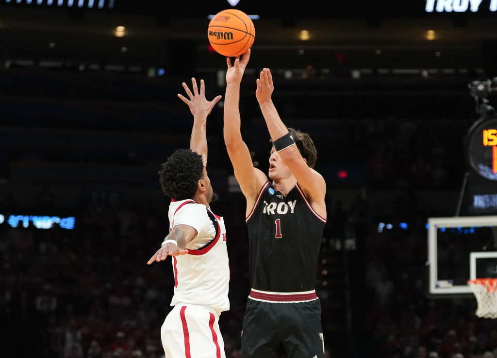 Troy forward Thomas Dowd, right, shoots over Nebraska guard Jamarques Lawrence during the first half in the first round of the NCAA college basketball tournament, Thursday, March 19, 2026, in Oklahoma City. (AP Photo/Kyle Phillips)