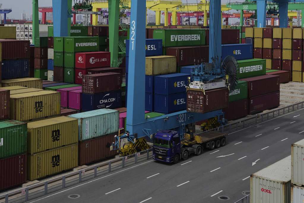 FILE - A crane loads a shipping container into a truck at an automated container port in Tianjin, China, Friday, Aug. 29, 2025. (AP Photo/Mahesh Kumar A., File)