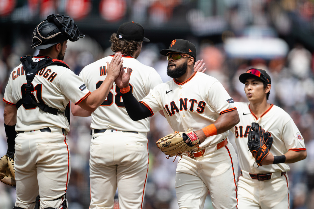 San Francisco Giants left fielder Heliot Ramos, second from right, celebrates with teammates after a baseball game against the Colorado Rockies, Sunday, July 12, 2026, in San Francisco. (AP Photo/Thien-An Truong)