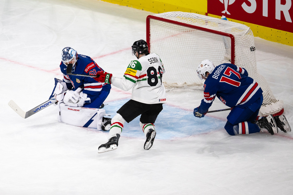 goaltender Joseph Woll of the U.S., left, concedes a goal from Hungary's Gabor Tornyai, not pictured, during the 2026 IIHF Men's Ice Hockey World Championship preliminary round group A game between United States and Hungary, in Zurich, Switzerland, Monday, May 25, 2026. (Andreas Becker/Keystone via AP)